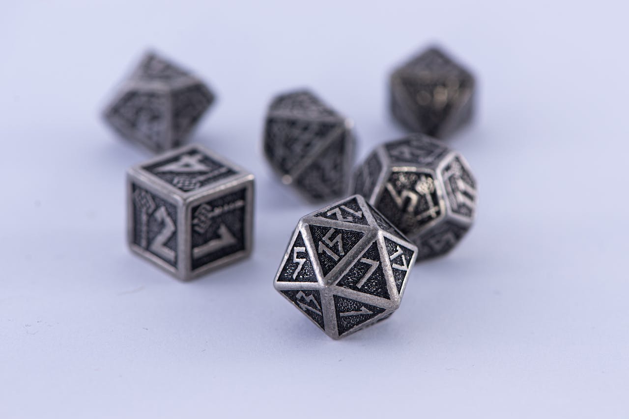 creative-03 Metal polyhedral dice set displayed on a white surface. Perfect for tabletop gaming enthusiasts.
